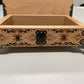 Decorative wooden box with intricate carvings on a white surface