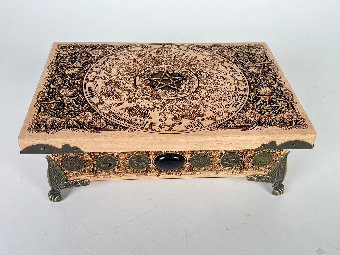 Decorative Wheel of the Year wooden box with intricate carvings and a pentagram design on a white background