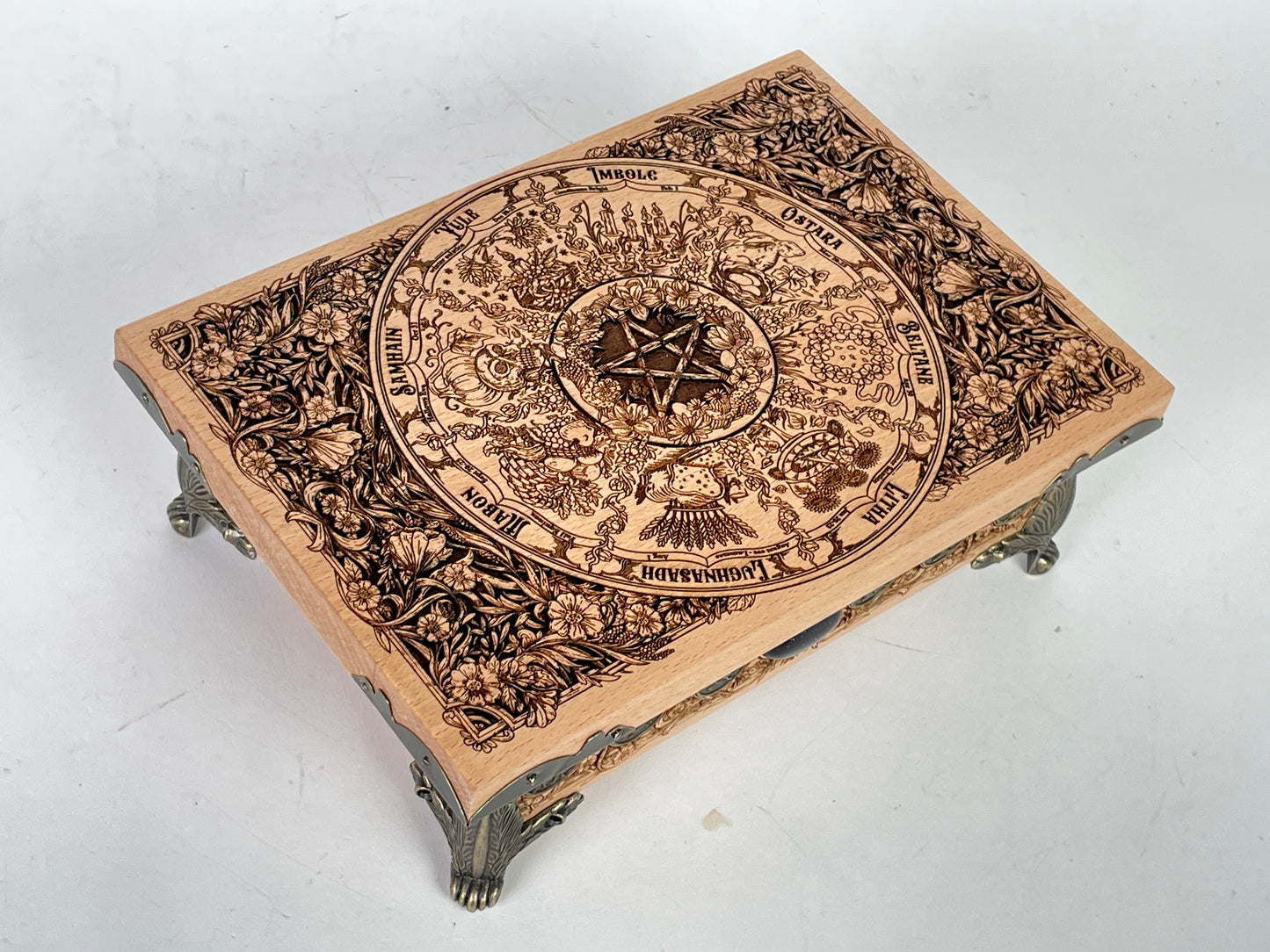 Close up of Wheel of the Year sabbat engraving on wooden altar table
