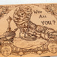Close up of Wonderland characters engraved on wooden keepsake box lid
