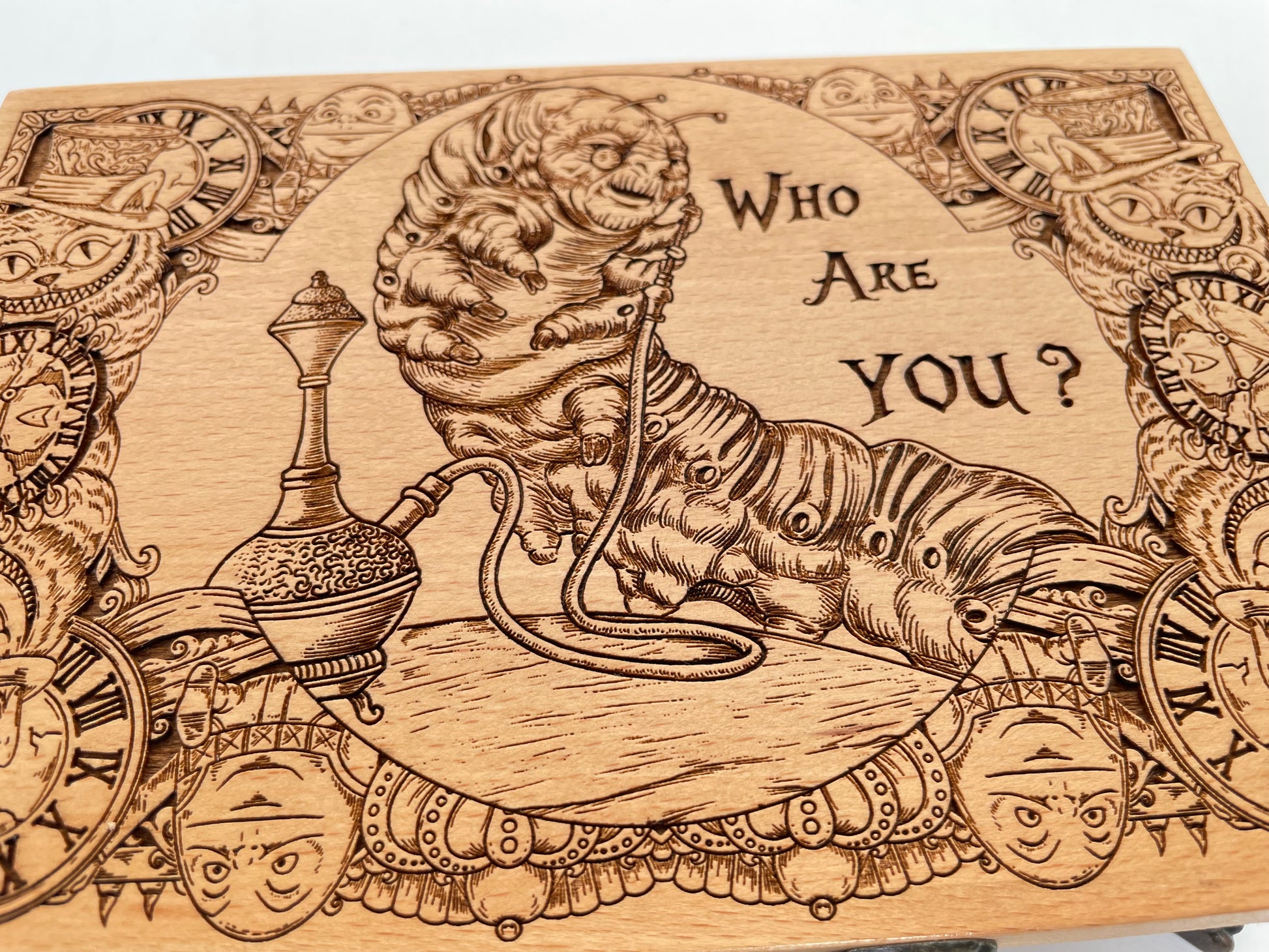 Close up of Wonderland characters engraved on wooden keepsake box lid
