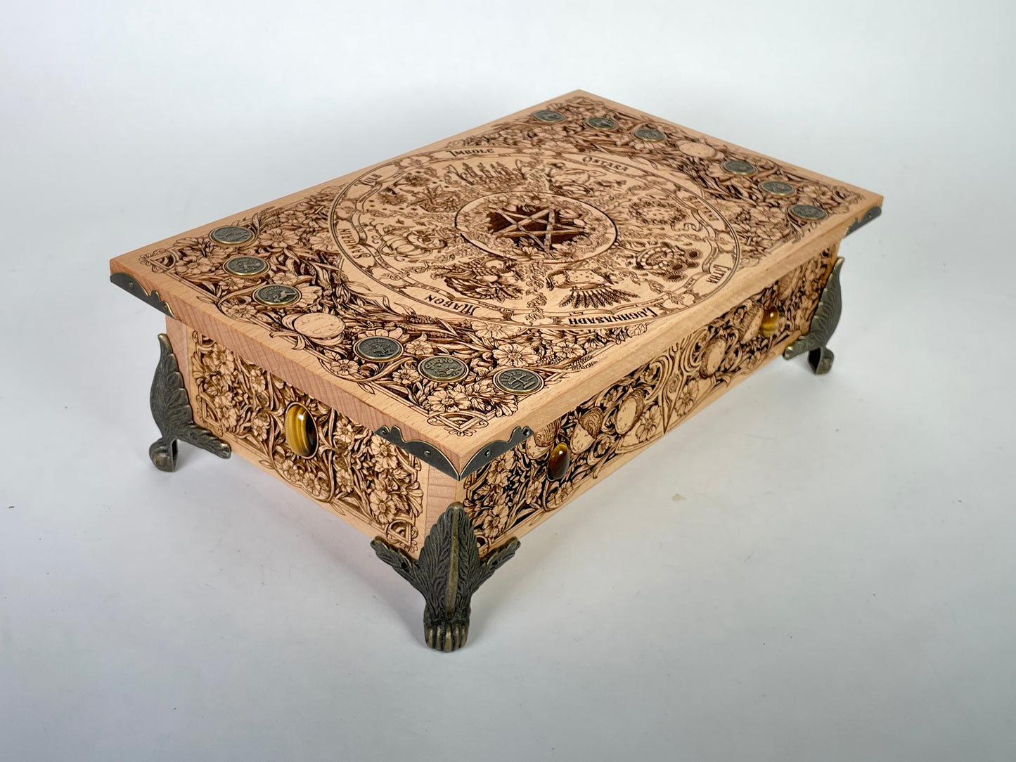 Close up of Wheel of the Year Yule engraving on wooden altar table
