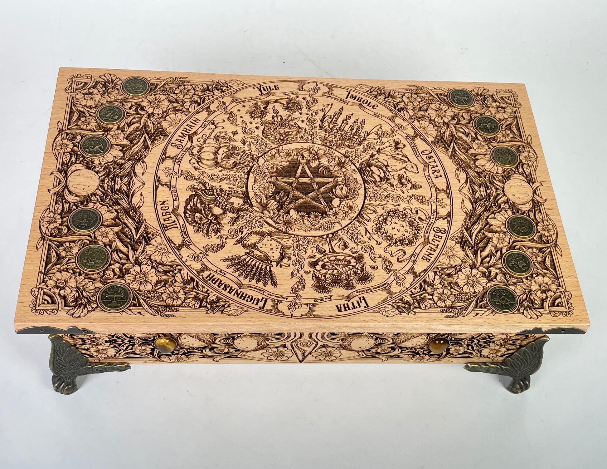 Big wooden altar table with built in storage holding tarot decks and crystals
