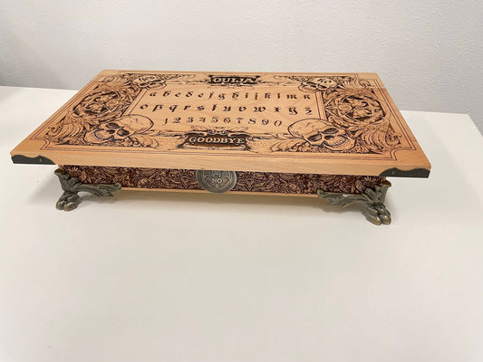 Handmade 2-in-1 Ouija board box set engraved in wood with gothic skull and demon design, includes planchette and storage compartment