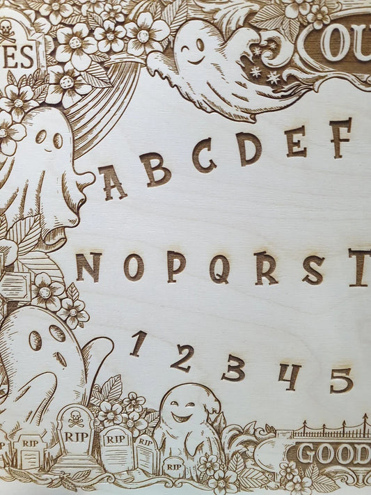 Close up of cute ghost and flower engraving on wooden spirit talking board
