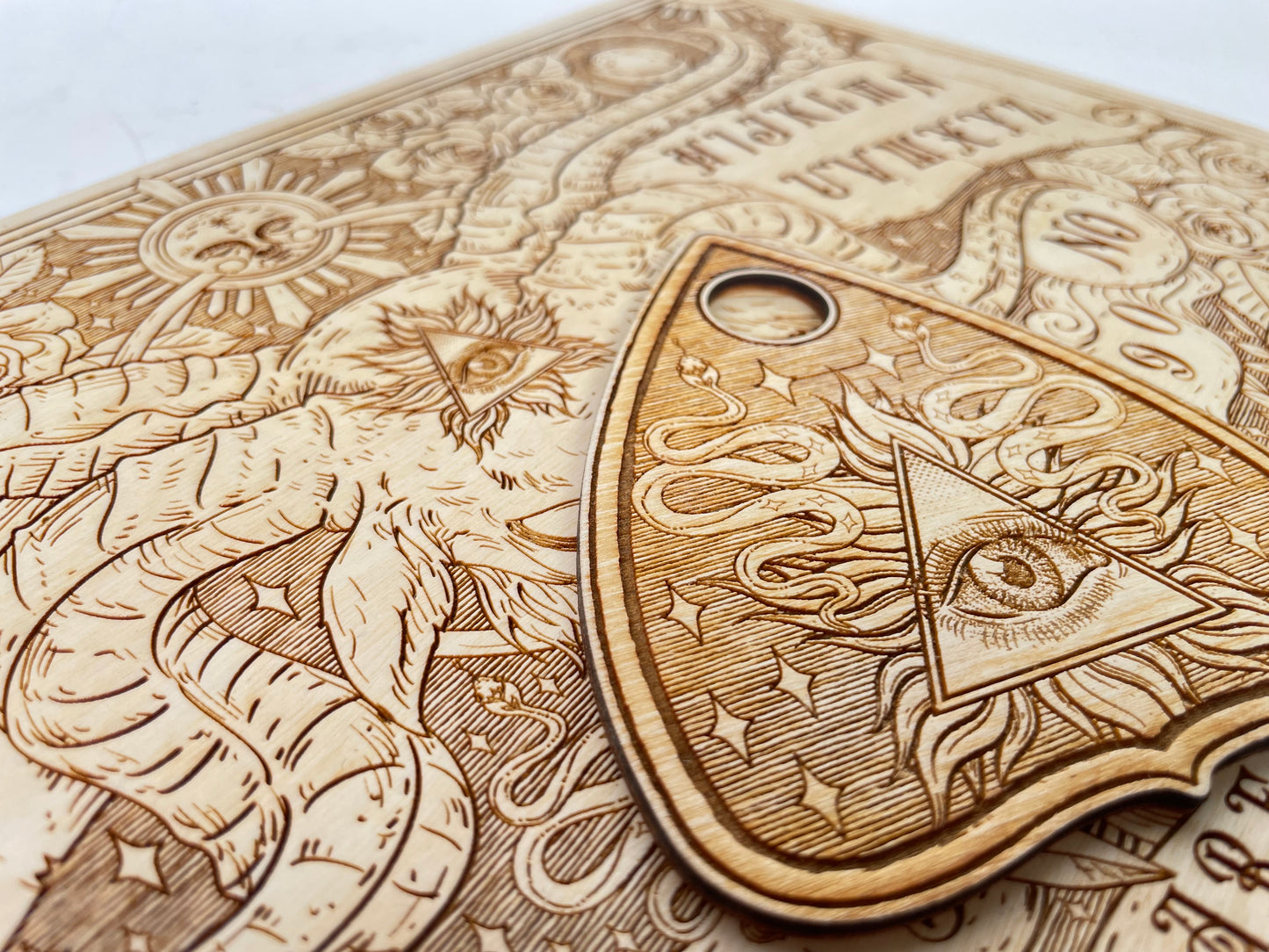 Close up of engraved rose and sun design on celestial wooden spirit board for positive pagan use
