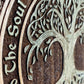 Close up of engraved Tree of Life and As Above So Below sacred design on wooden wall decor