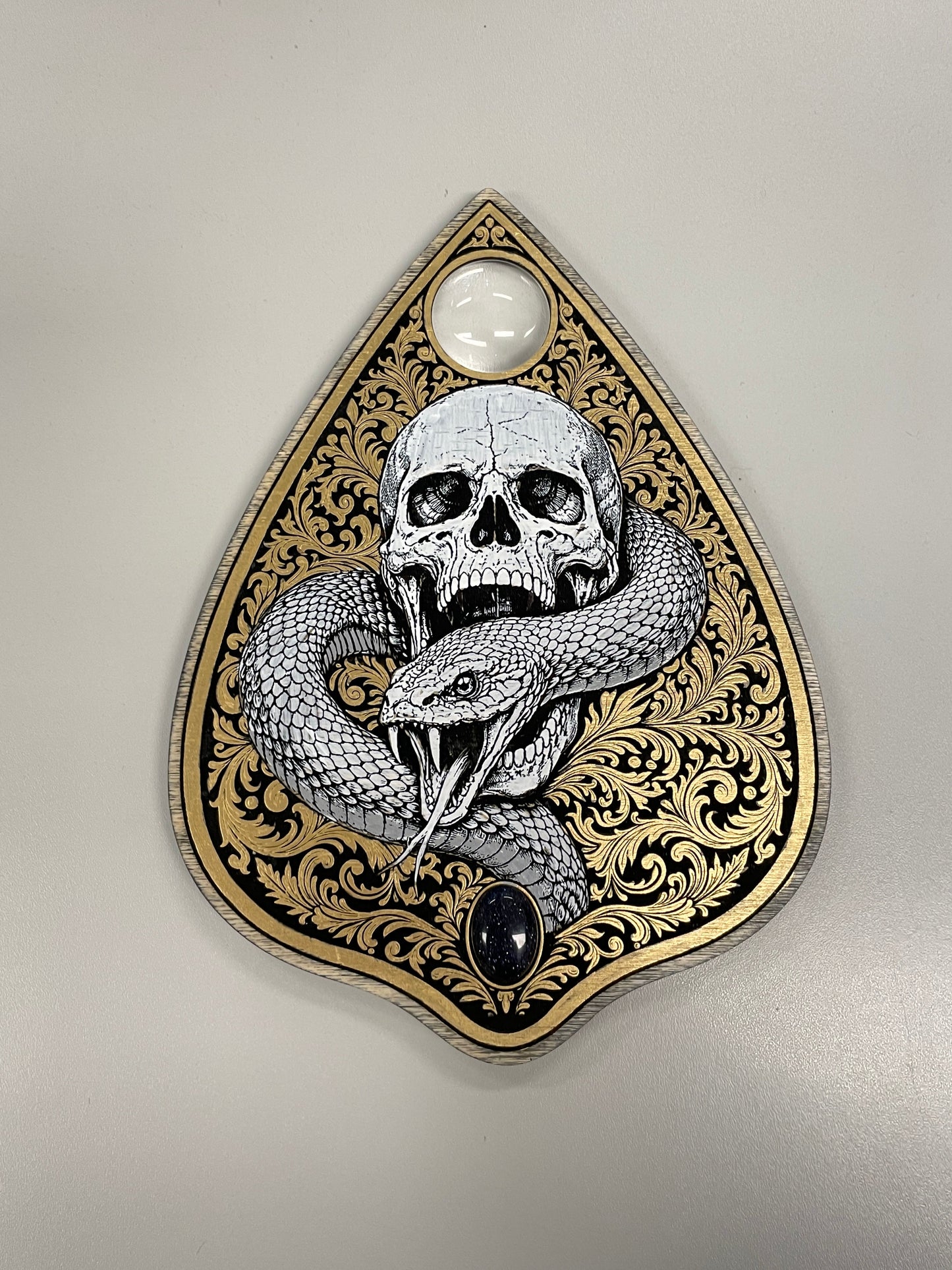 Skull serpent gothic wooden Ouija board planchette with glass lens and blue stone
