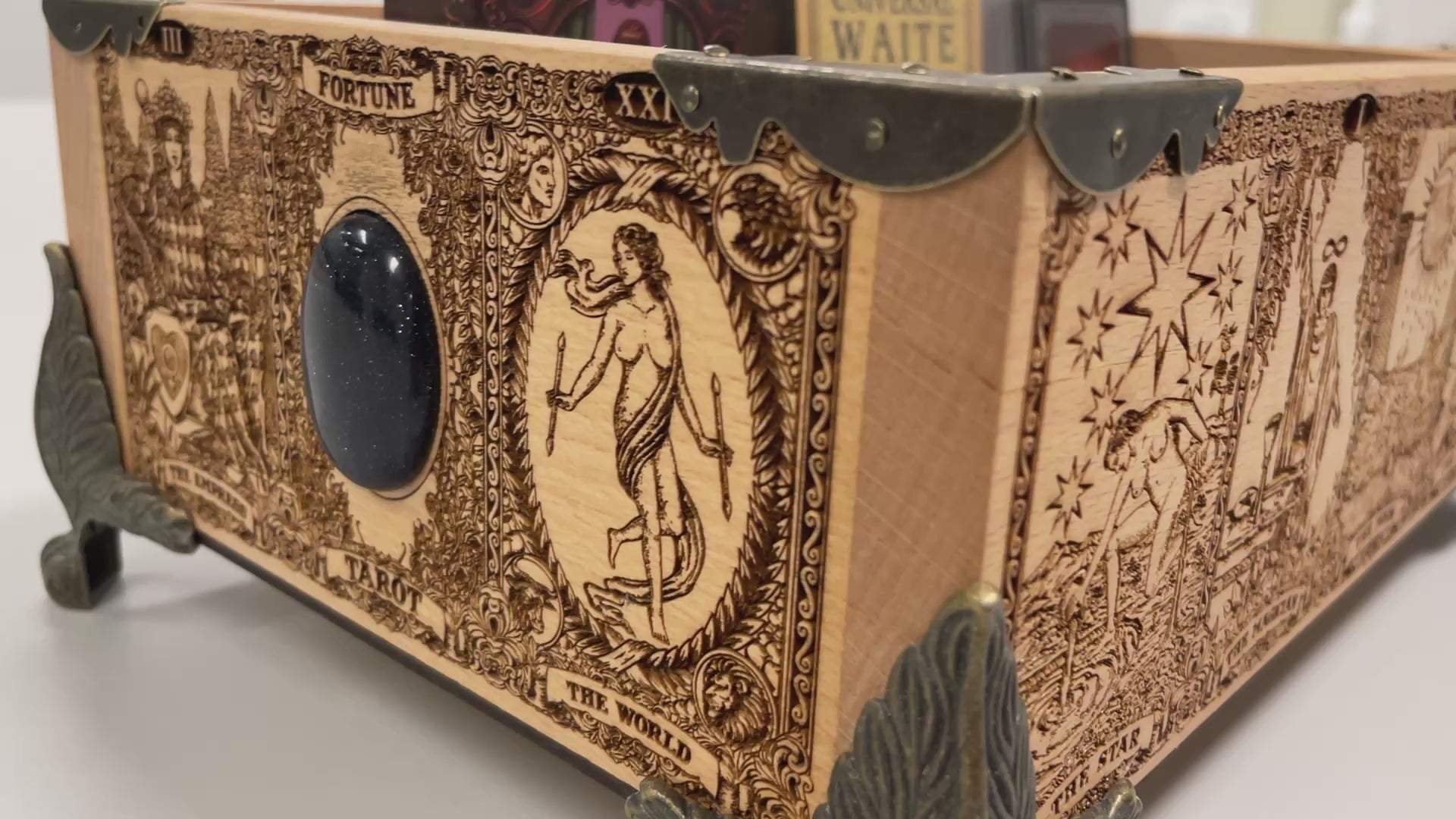 Video of Tarot and oracle deck organizer solid wood box with 12 removable slots engraved with Major Arcana Empress and zodiac symbols
