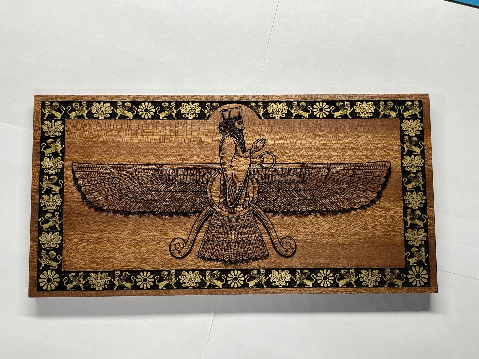 Video of Ahura Mazda Faravahar wall art engraved in solid mahogany wood, Zoroastrian Persian symbol with hand painted details, handmade spiritual wall decor
