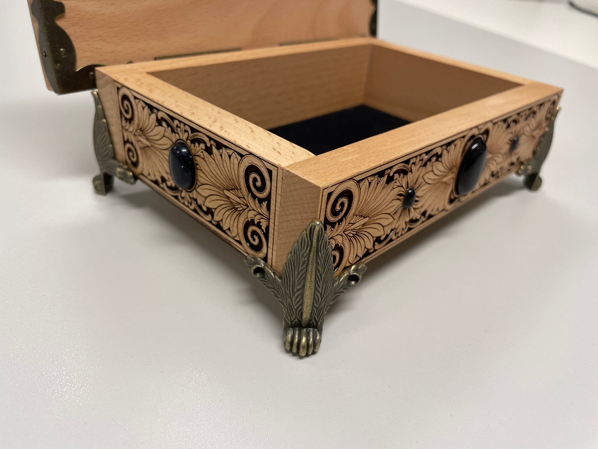 Wooden tarot box with intricate carvings on a white background