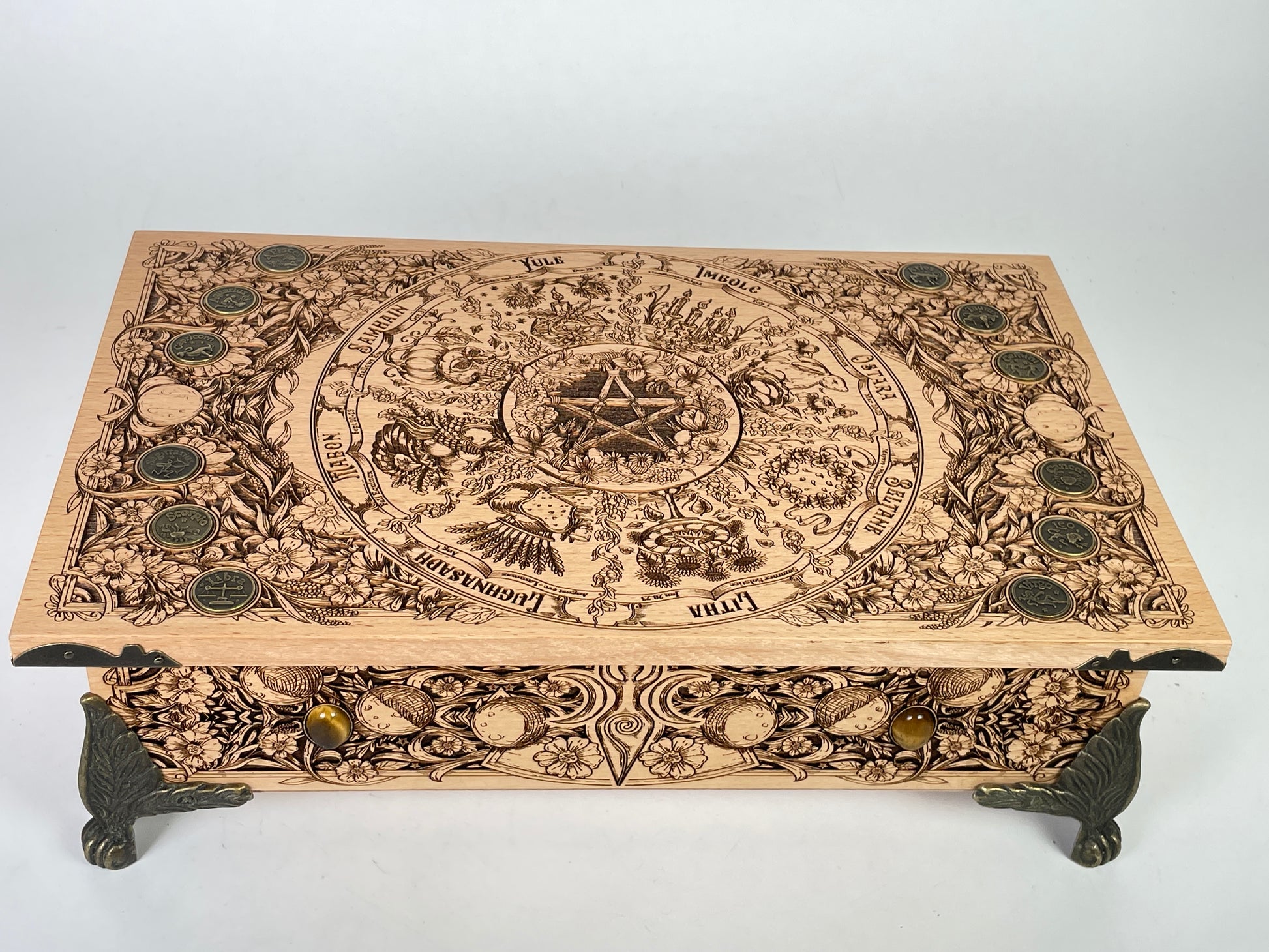 Close up of Wheel of the Year sabbat engraving on wooden altar table

