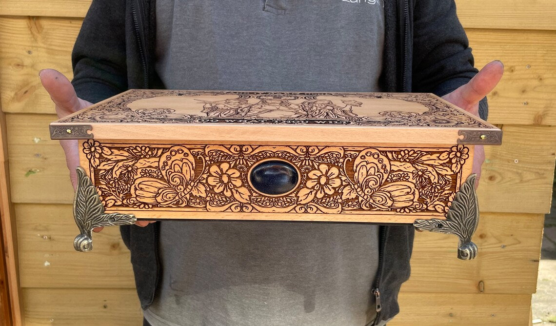 Close up of Triple Moon Goddess engraving on luxury Wiccan altar board
