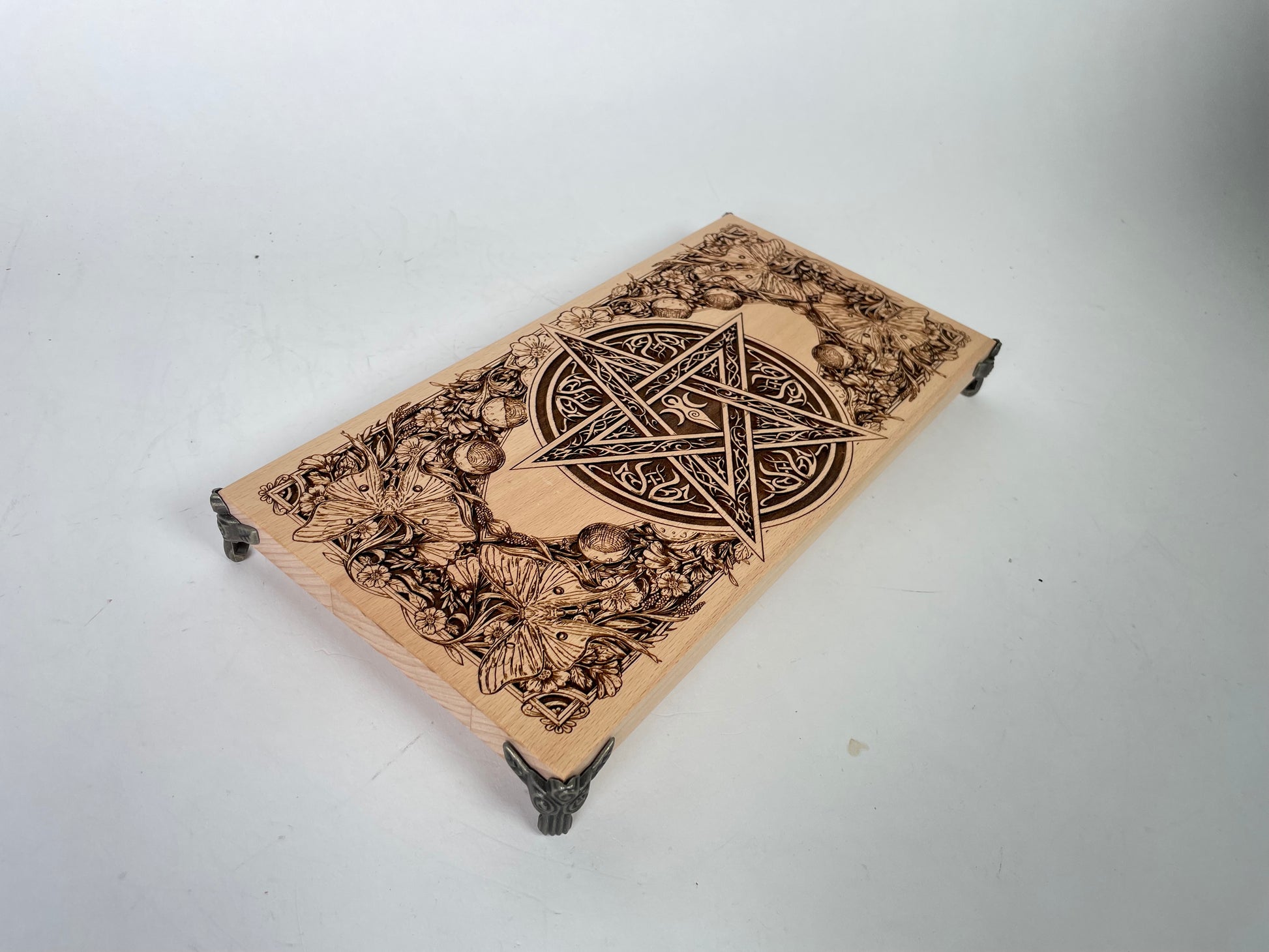 Close up of Celtic pentagram engraving on wooden ritual altar table

